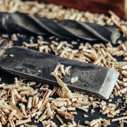 old-hand-plane-drill-chisel-with-wooden-shavings-black-background-old-woodworking-hand-tool-copy-empty-space-text